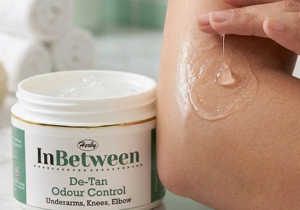 Applying a clear water based skin brightening gel onto smooth skin to clear dark spots