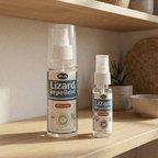 Herby Lizard Repellent spray bottles, 100ml and 30ml sizes, displayed on a wooden shelf beside a small plant.