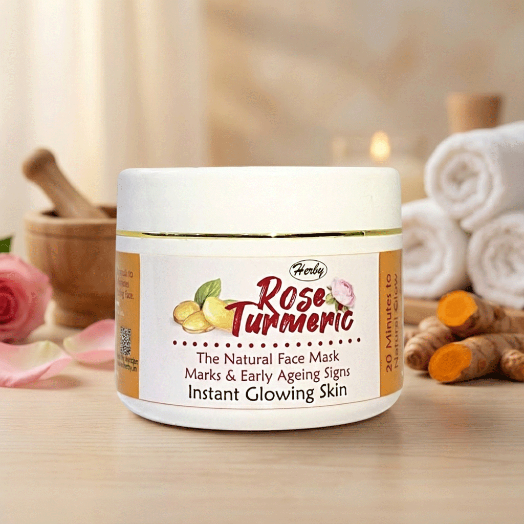 Herby Rose Turmeric face mask jar on a wooden table with roses, turmeric root, and towels for a natural glow.
